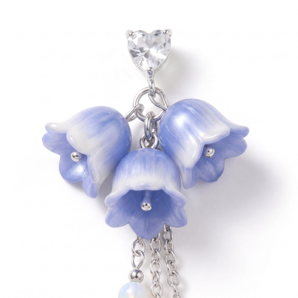 Close detail of the blue bell flowers and heart-cut stone