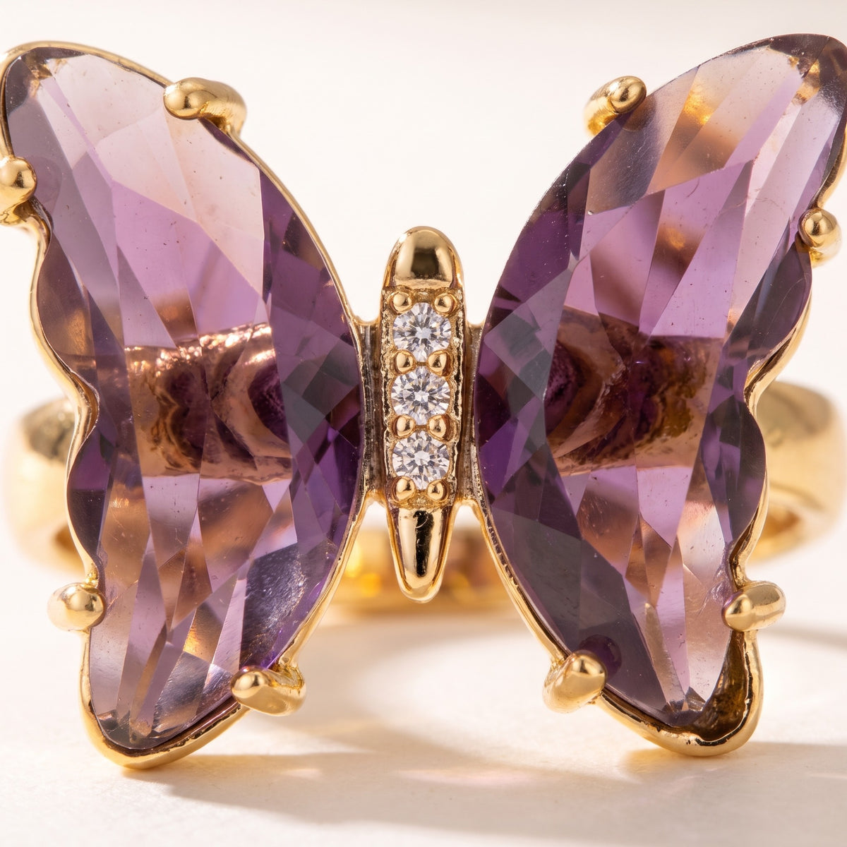 Close detail of the faceted wings and pave-set body