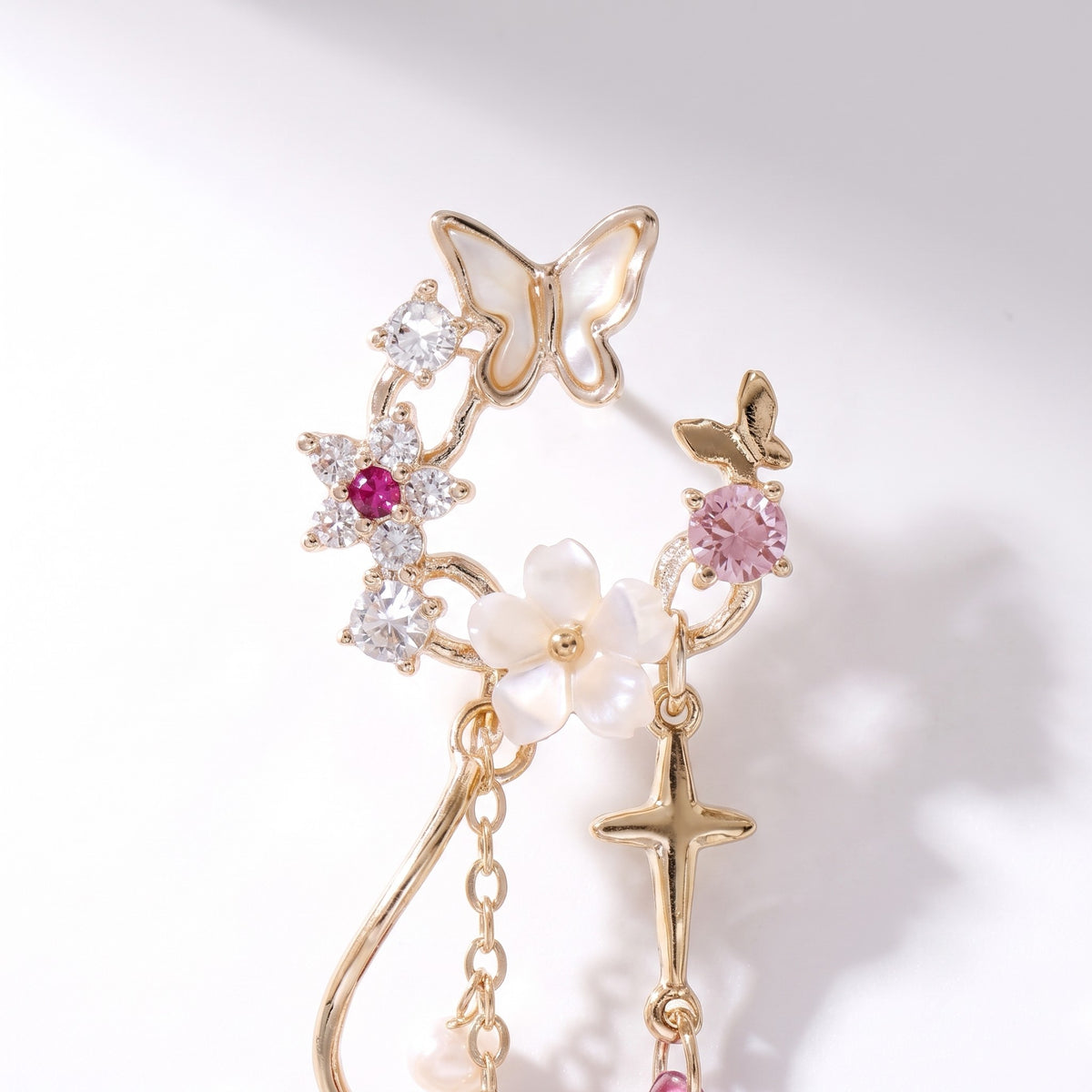Close detail of the butterfly, star, blossom and cross charms