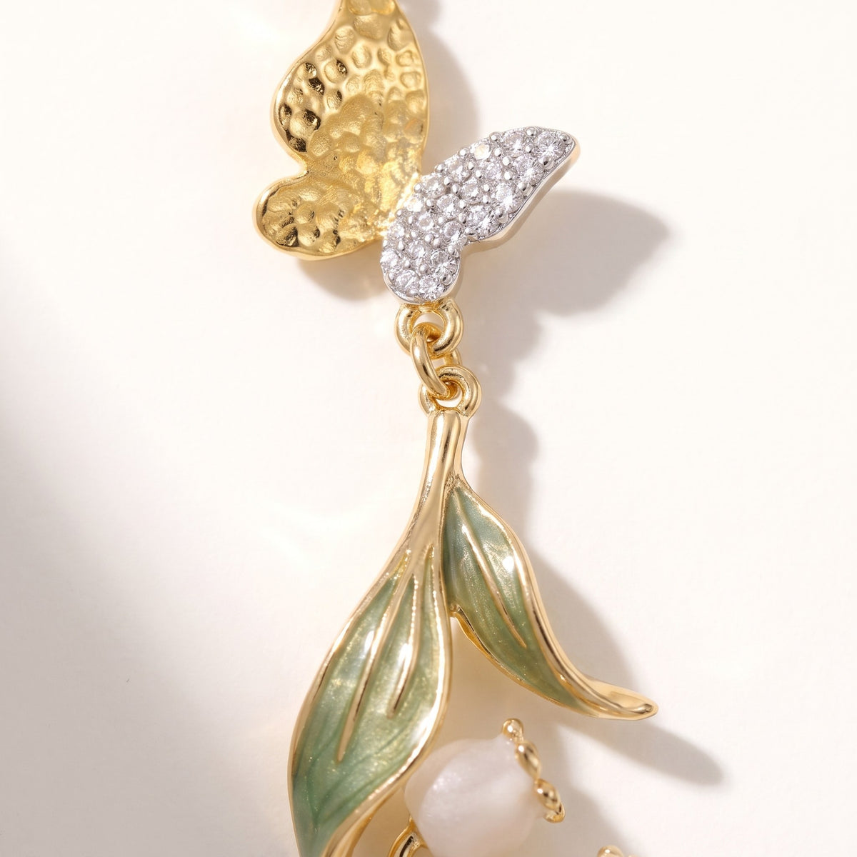 Close detail of the hammered butterfly and green enamel leaf