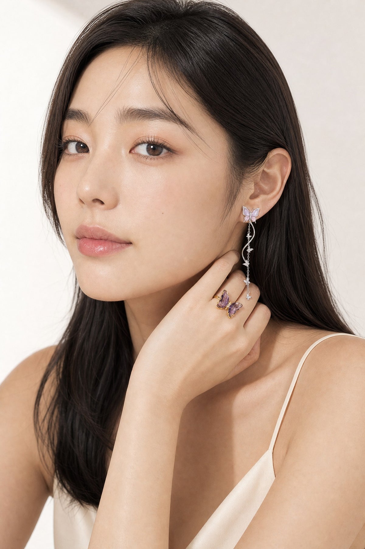 Nabi Pair, Violet worn — the earring at the ear and the ring on the hand