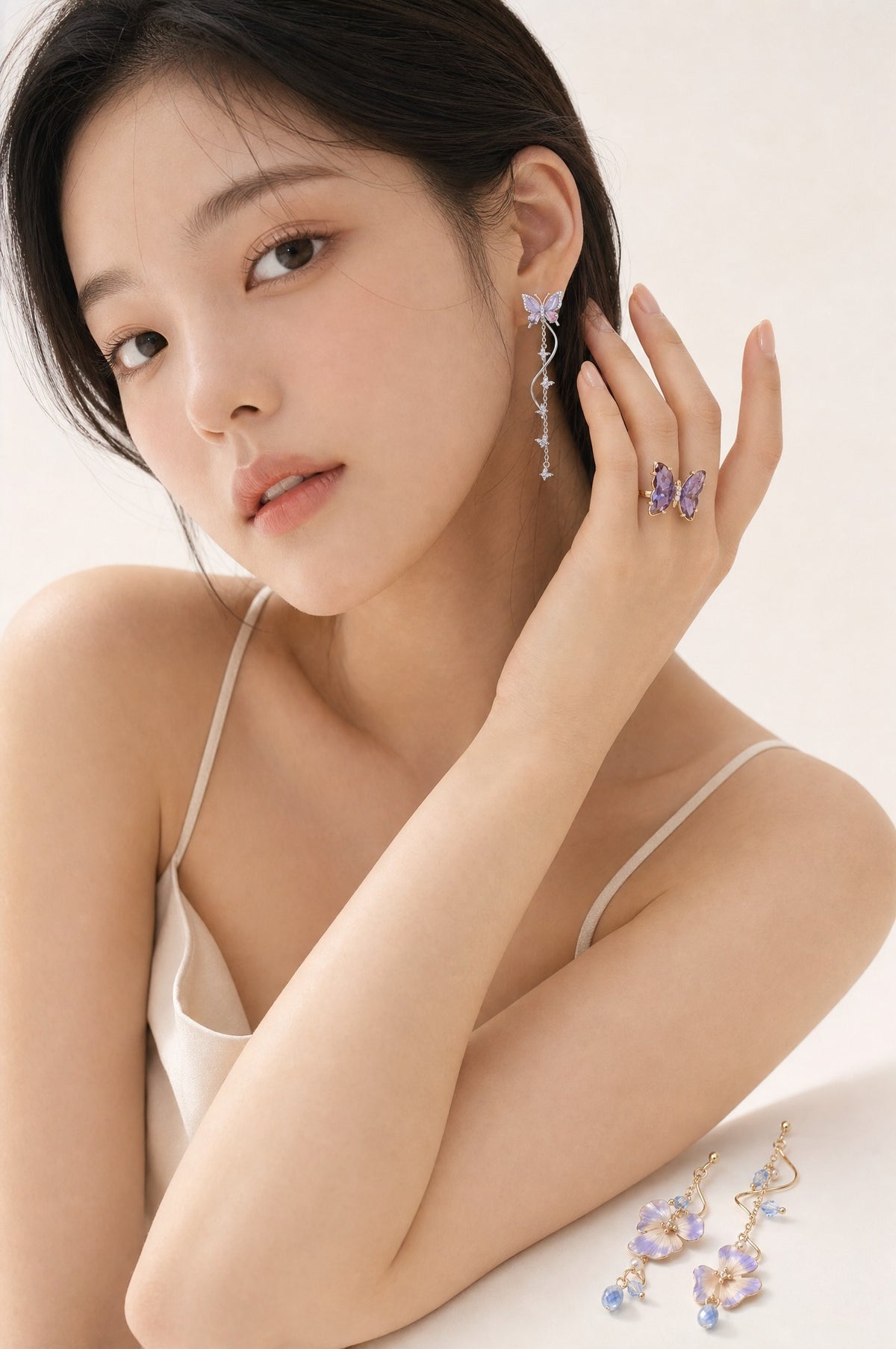 The Violet Set worn — earring and ring on the model, the second pair beside her