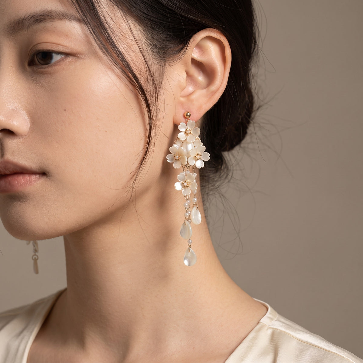 Moonpetal Earrings worn on the ear, hair up