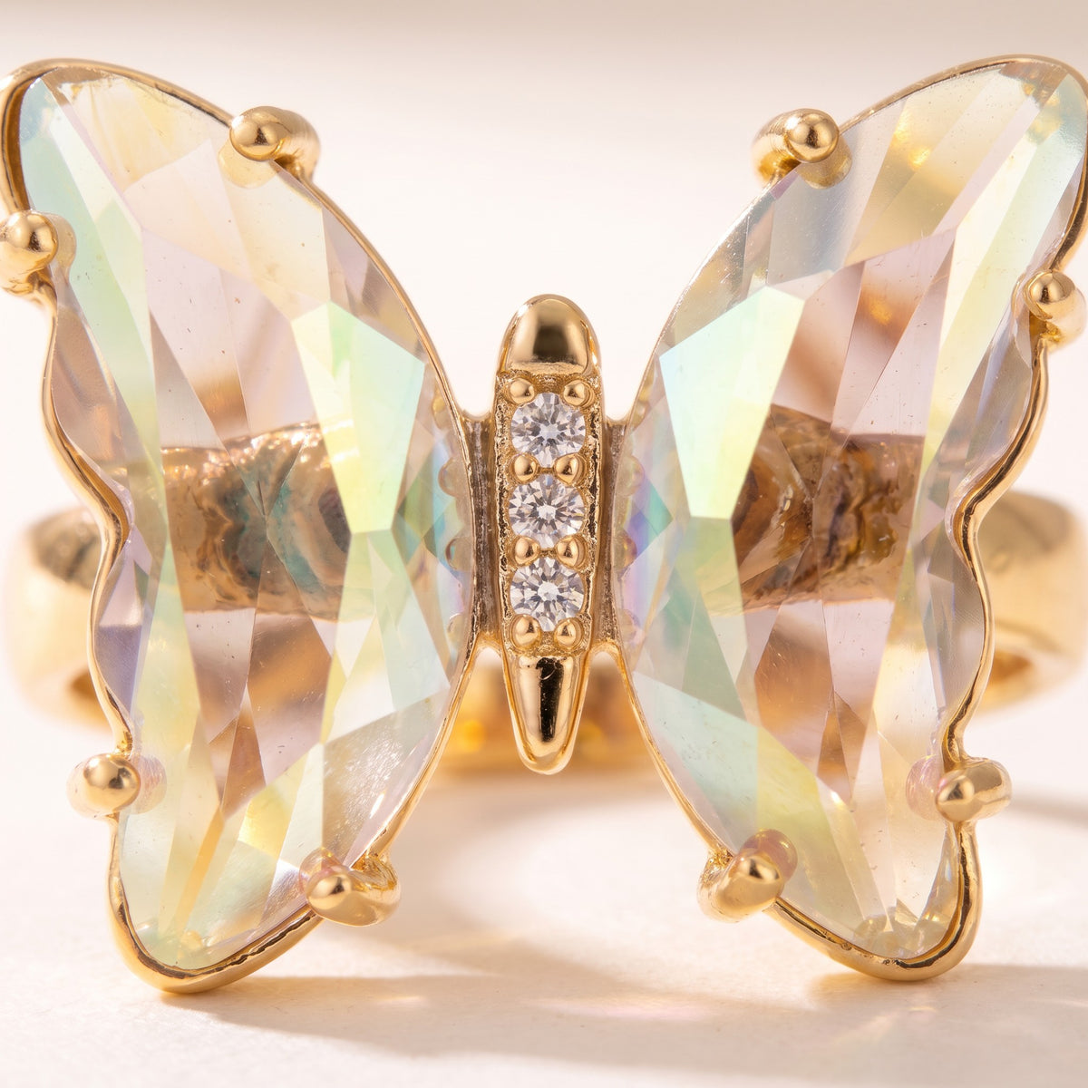 Close detail of the faceted wings and pave-set body