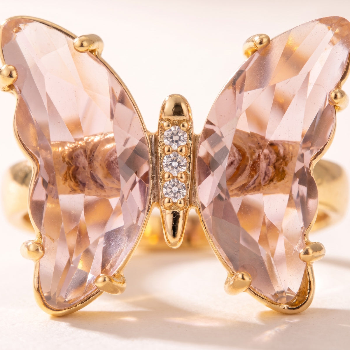 Close detail of the faceted wings and pave-set body