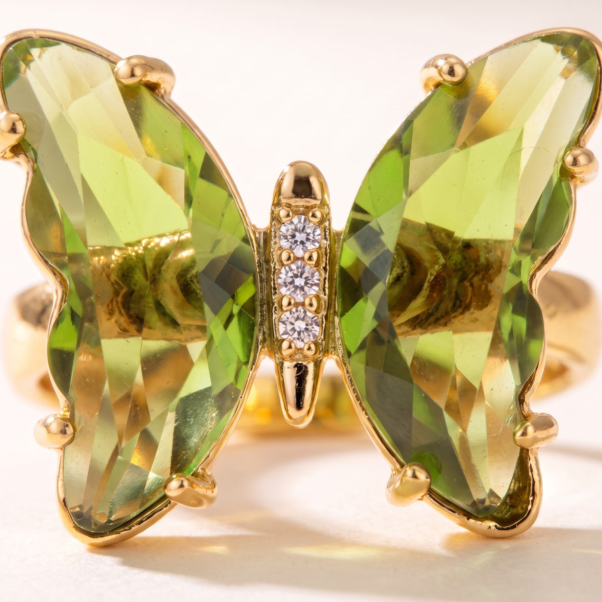 Close detail of the faceted wings and pave-set body