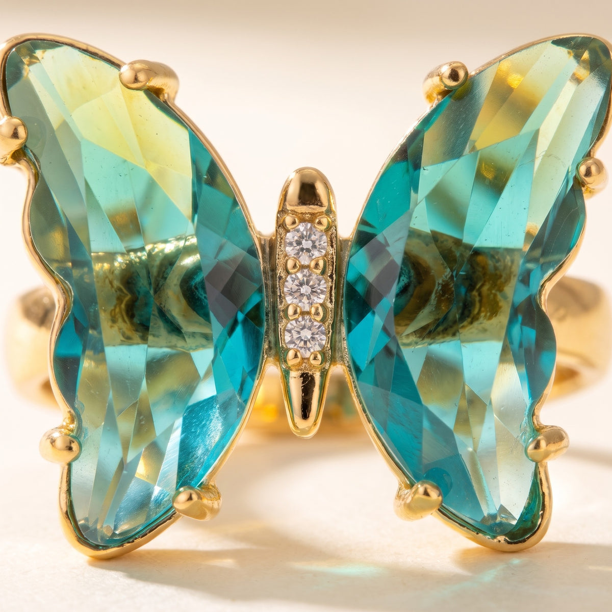 Close detail of the faceted wings and pave-set body