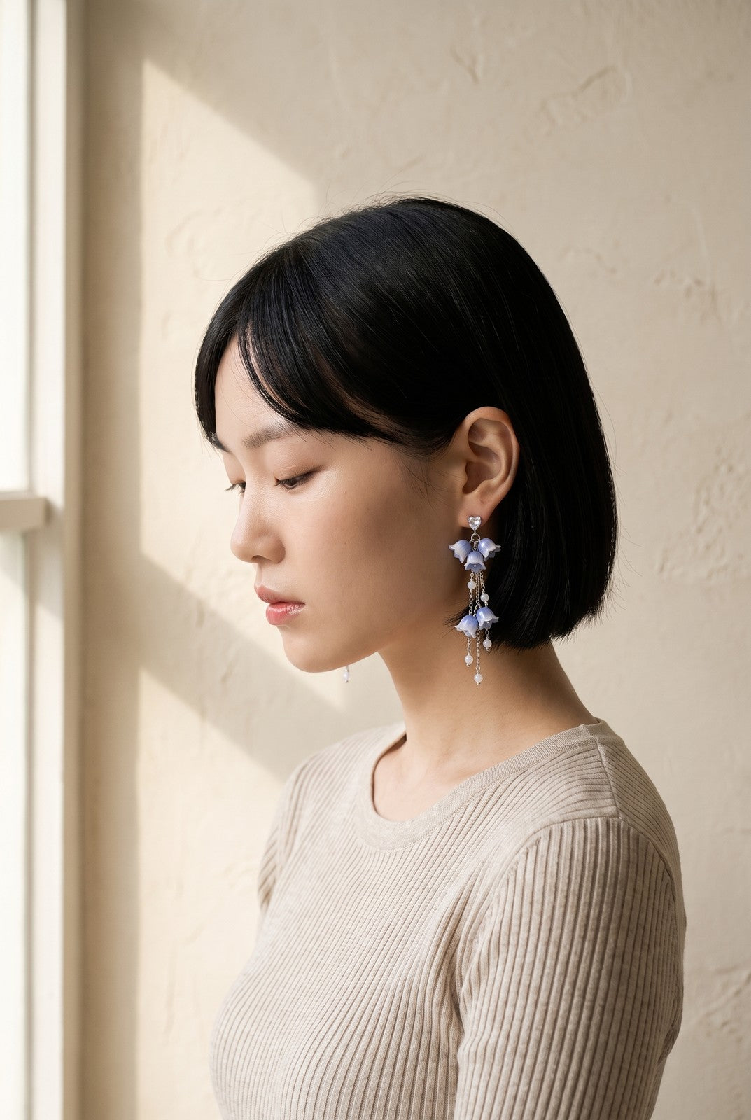 The Bluebell Earrings worn in profile, hair tucked behind the ear
