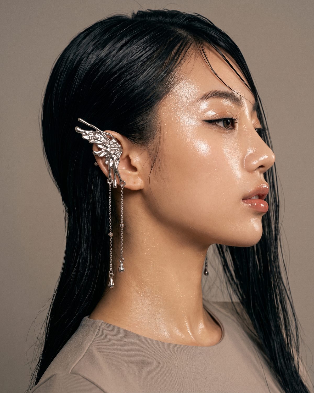 A Seraph Earring hooked over the upper ear