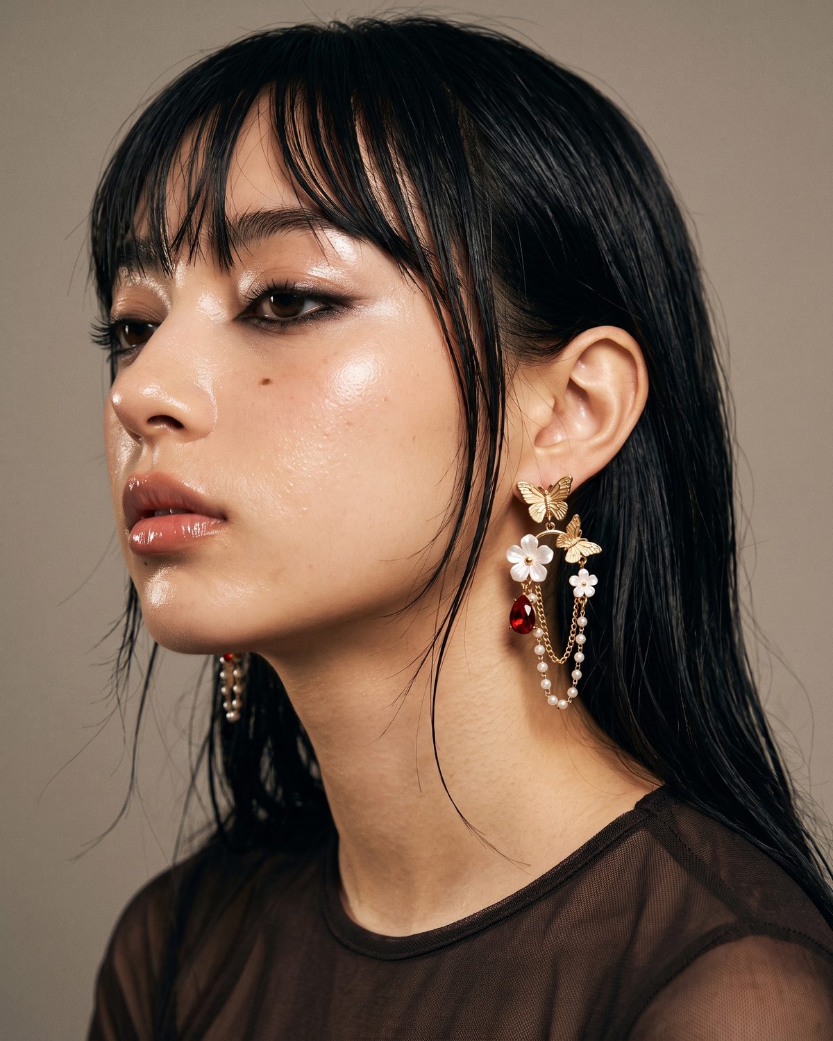 The Starfall Earrings worn against the neck